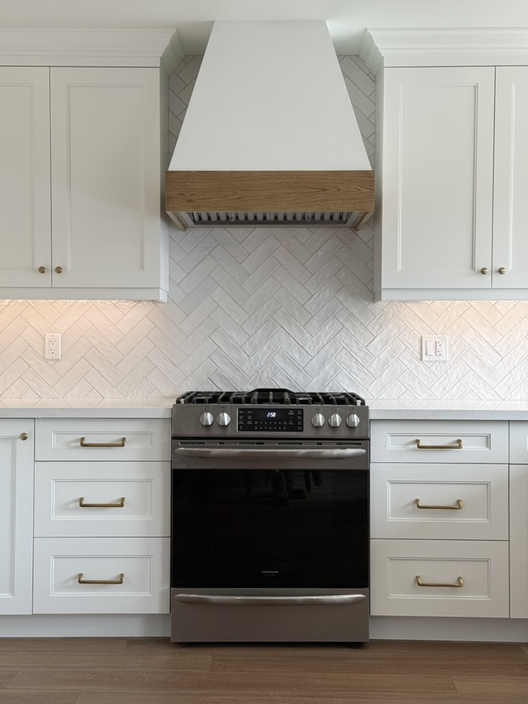 Custom range hood and coordinated cabinetry