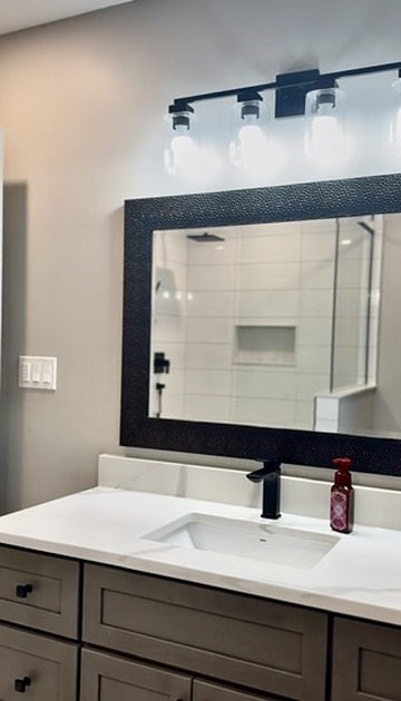 Wood vanity, quartz top and black faucet