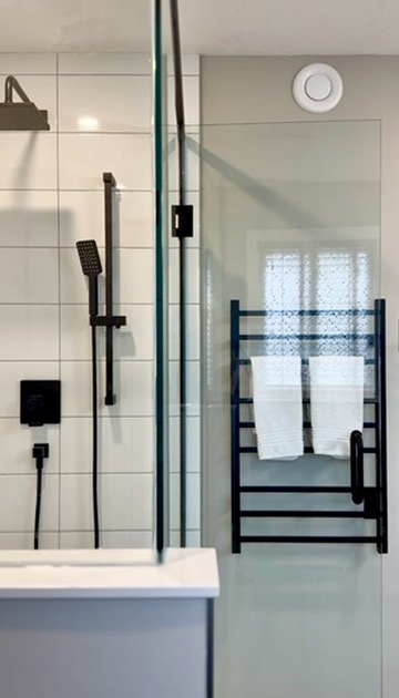 Custom shower glass and matte-black fixtures