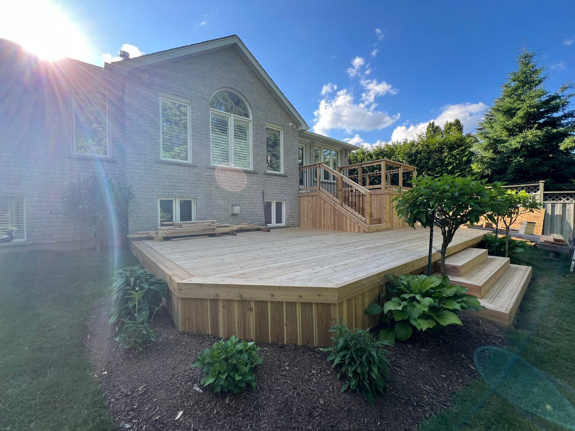 Wide view of the completed cedar deck and broad stairs