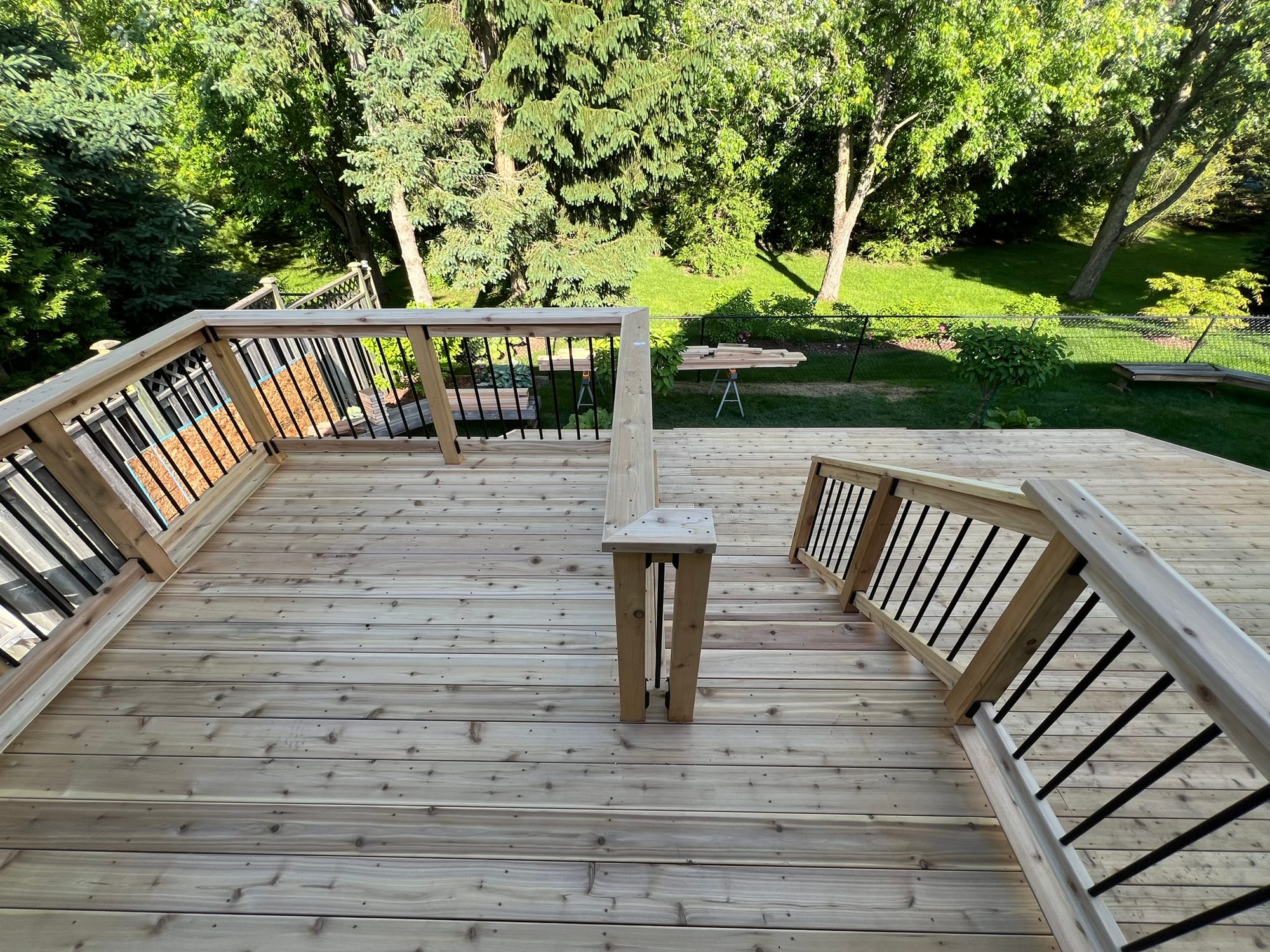 Cedar decking, integrated seating and black metal balusters