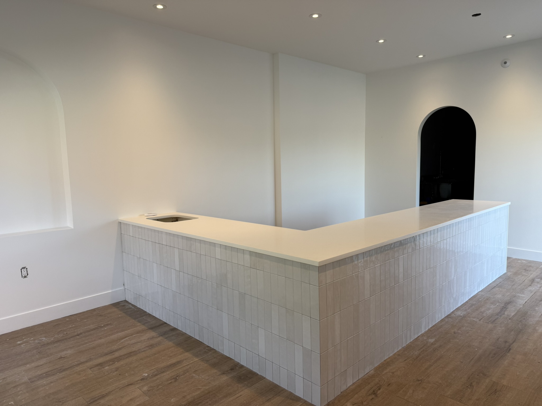Completed quartz-topped counter and arched wall opening